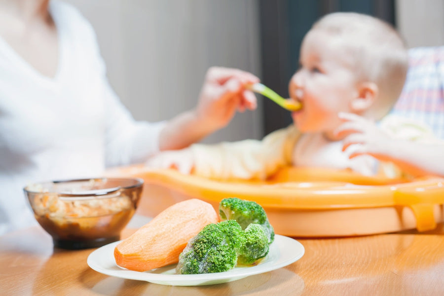 Mother feeding her baby but also focusing on her healthy diet after c-section