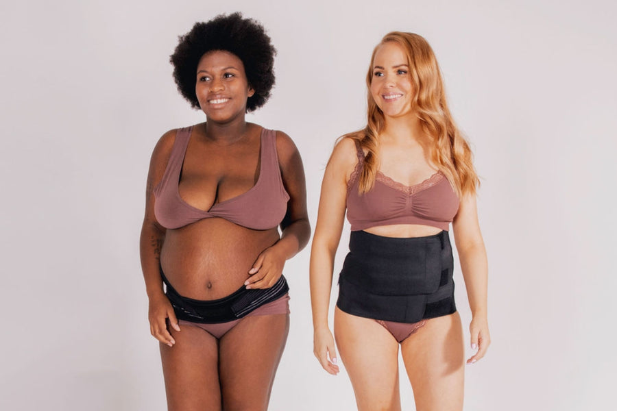 Two women wearing Lola&Lykke pregnancy and postpartum support bands and smiling at each other