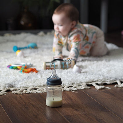 crawling baby on floor with baby battle