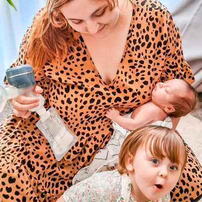 mother with her children while holding a breast pump