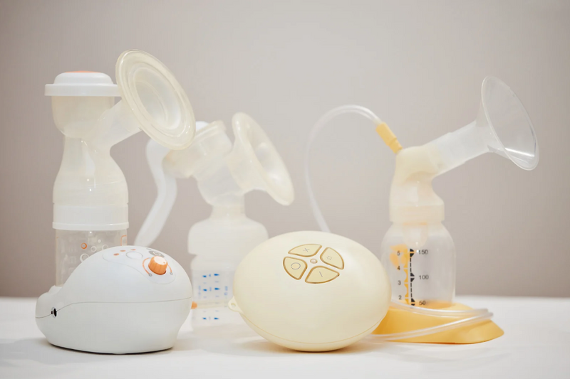 Various breast pumps displayed on a table.