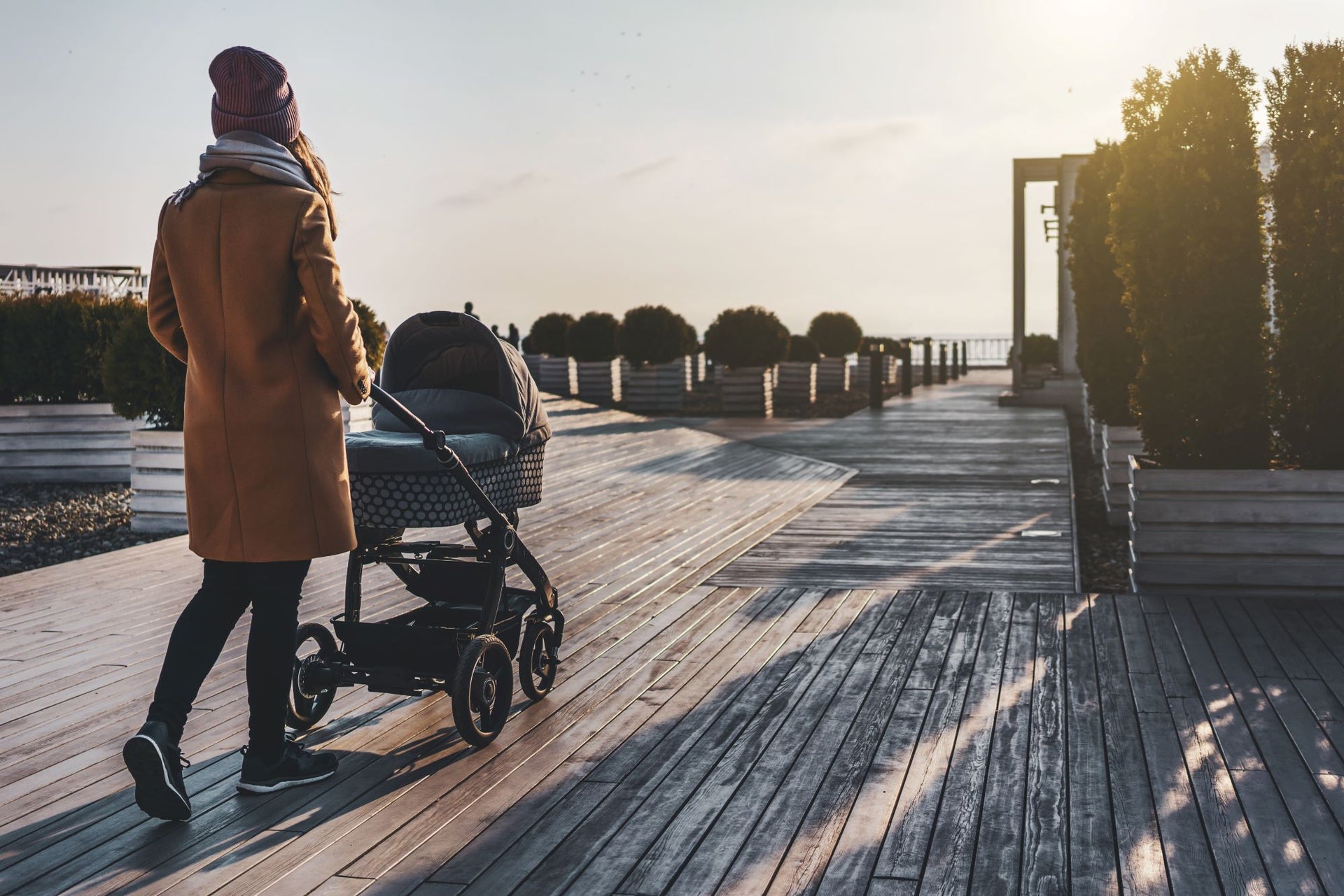 Postpartum mom exercising safely with walking the baby on a stroller