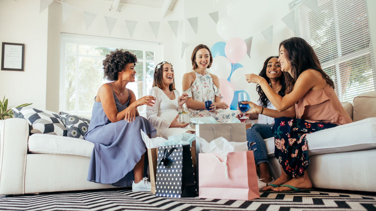Guests at a baby shower opening gifts and having fun
