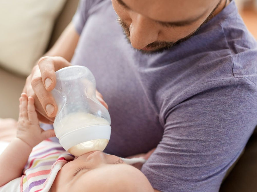 Father bottle-feeding a baby