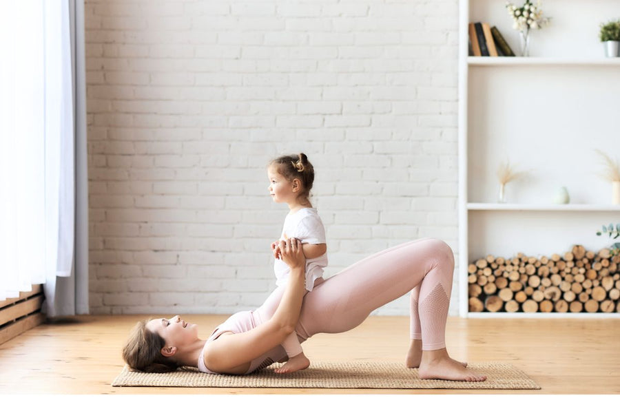 Mother performing pelvic floor exercises while holding her baby