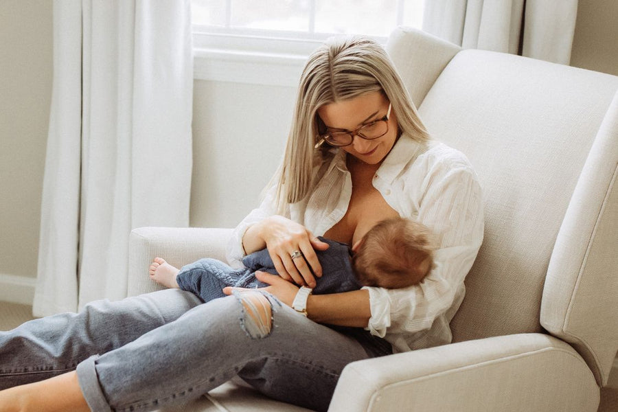 Mother breastfeeding her child on her lap with tips on how to relieve pain