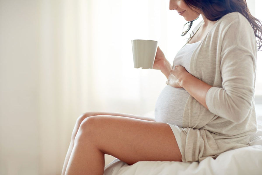 Pregnant woman relaxing and savoring a cup of tea