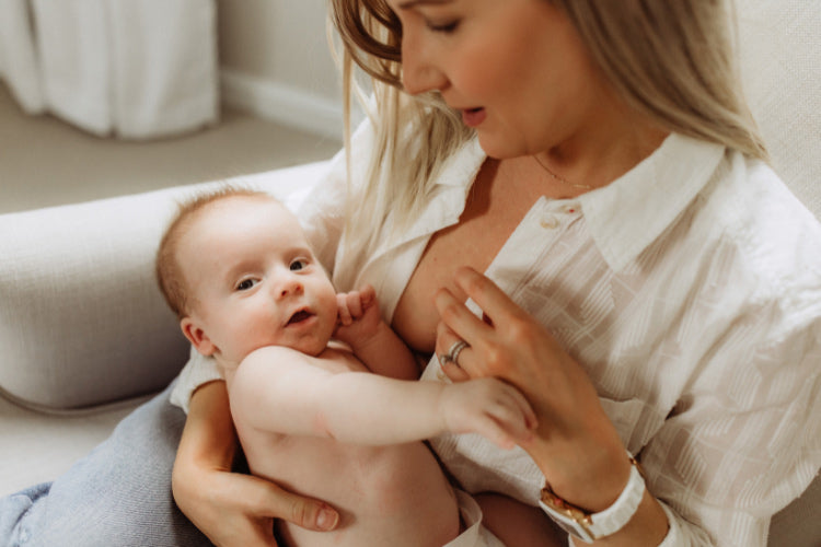A mother attempting to breastfeed, but the baby is experiencing a nursing strike