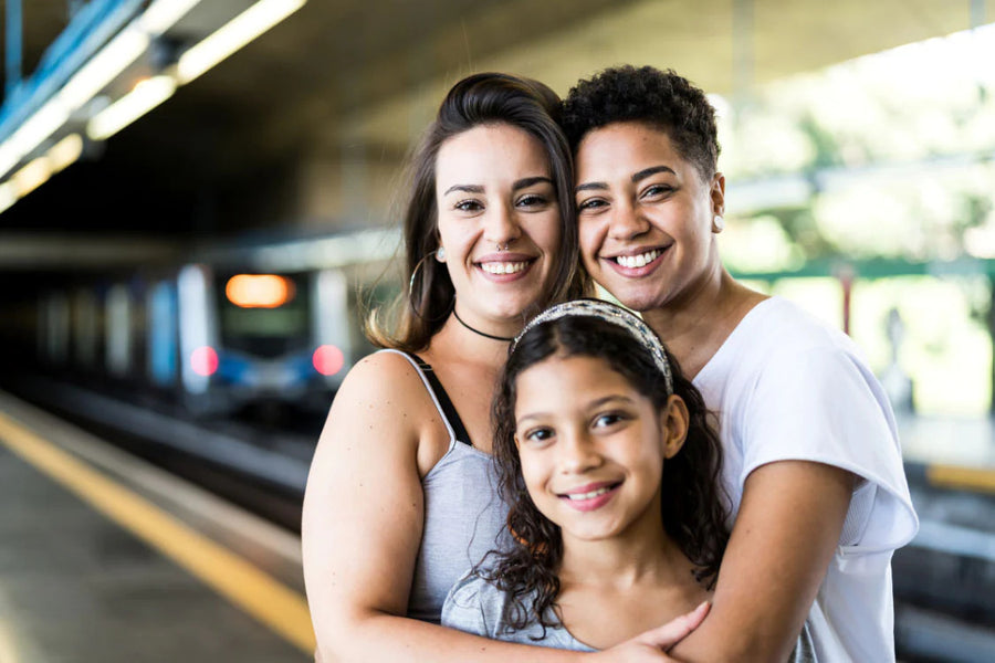 Two moms raising a daughter, standing in train station
