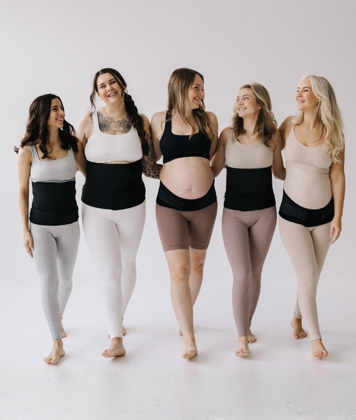 Five women walking towards camera while wearing maternity support belts, for pregnancy or for postpartum