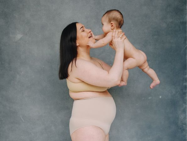 postpartum recovery mum holding a baby